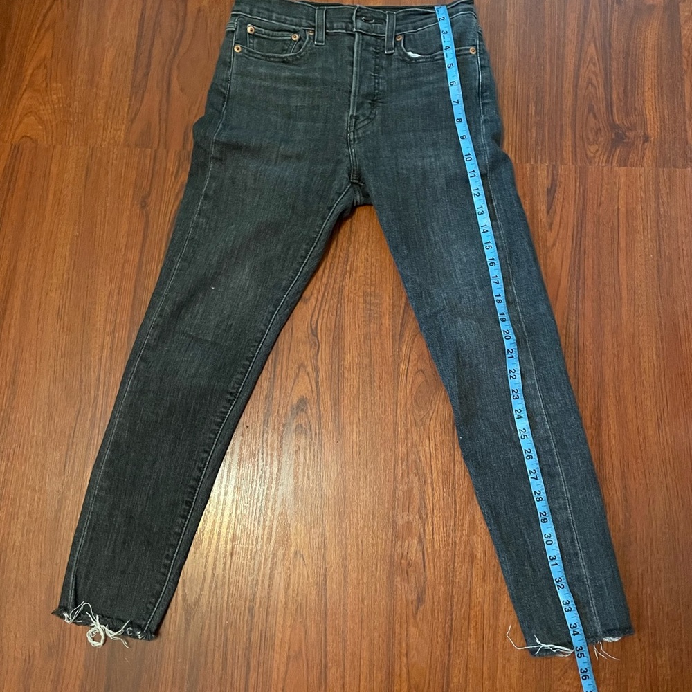 Levi’s “Wedgie skinny” black washed jeans, flares at the bottom.